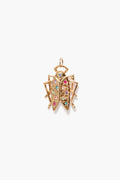 A gold beetle-shaped pendant from Goldbug x Tuckernuck sparkles with rainbow-hued Swarovski crystals, capturing the brand’s whimsical essence.