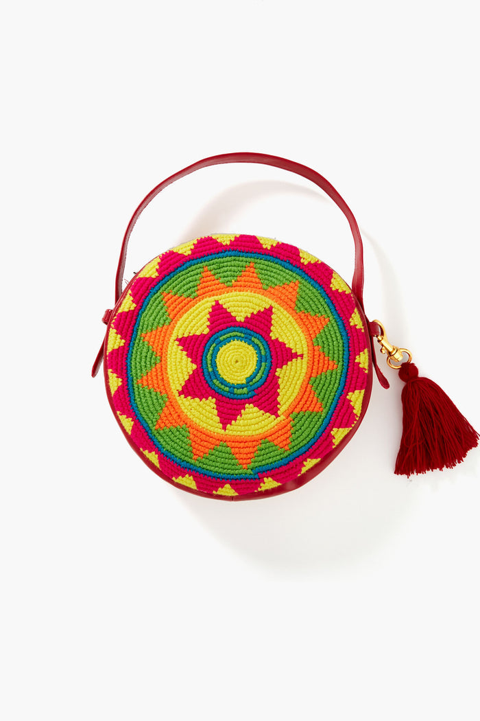 Colorful and vibrant, this handwoven Marina Orth Foundation bag from San Jacinto, Colombia, features a geometric yellow, green, red, and orange pattern with a matching red handle and tassel for a lively touch.