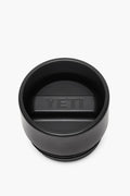 YETI black tumbler lid with a central raised handle and embossed logo, crafted as an insulated, leakproof cap for your Rambler bottle.
