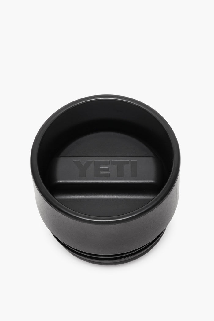 YETI black tumbler lid with a central raised handle and embossed logo, crafted as an insulated, leakproof cap for your Rambler bottle.
