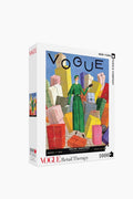 The New York Puzzle Company’s 1000-piece Vogue Cover puzzle showcases Georges Lepape’s vintage illustration of a woman in a green dress with shopping bags—an ideal gift for puzzle lovers.