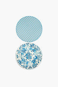 Two round plates from Holly Stuart Home with blue and white designs—the top has a geometric pattern, the bottom a floral motif—ideal as inspiration for handcrafted placemats or as a thoughtful hostess gift.