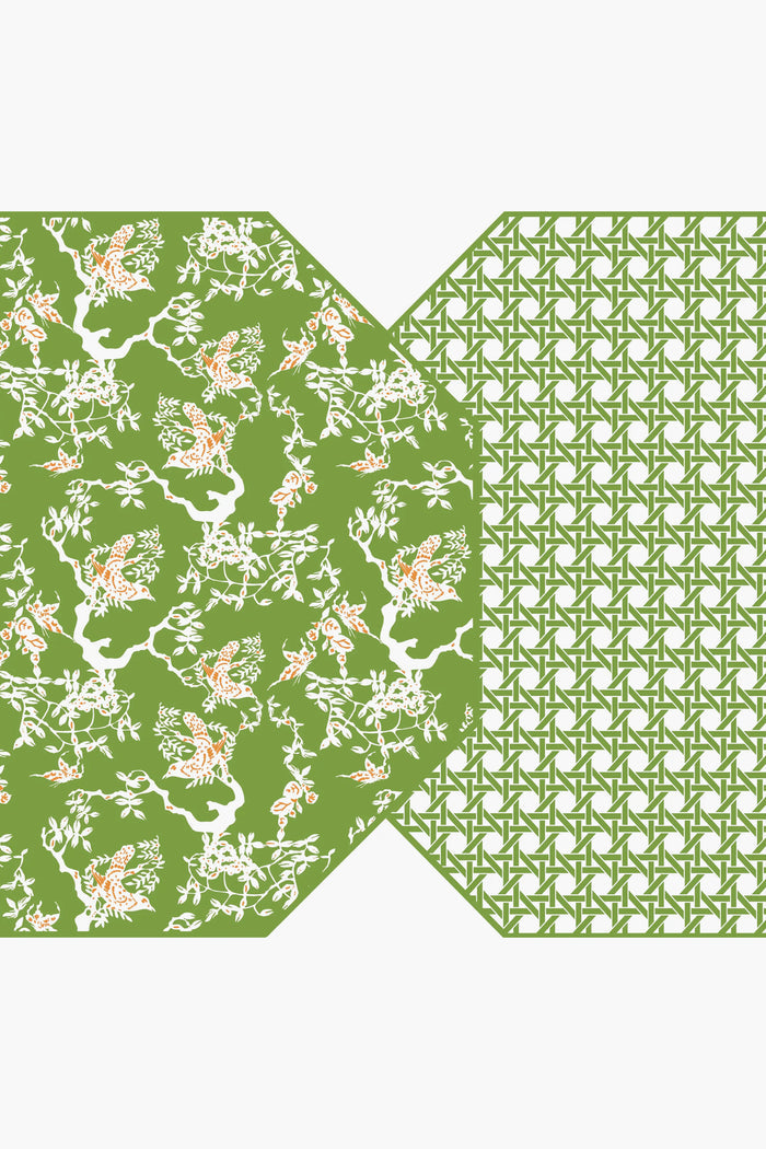 A green geometric pattern on the right overlaps with a green floral bird and branch motif on the left—Holly Stuart Home's reversible placemats, ideal for enhancing your handcrafted tableware and dining room decor.