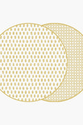 Holly Stuart Home offers two overlapping round mats with gold patterns, featuring a small leaf design on the front and a geometric pattern on the back. These handcrafted table decor pieces double as reversible placemats for versatility.