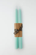 Two Greentree Home Robins Egg Blue hand-poured candles are bundled together with a corrugated cardboard sleeve and finished with a brown ribbon.