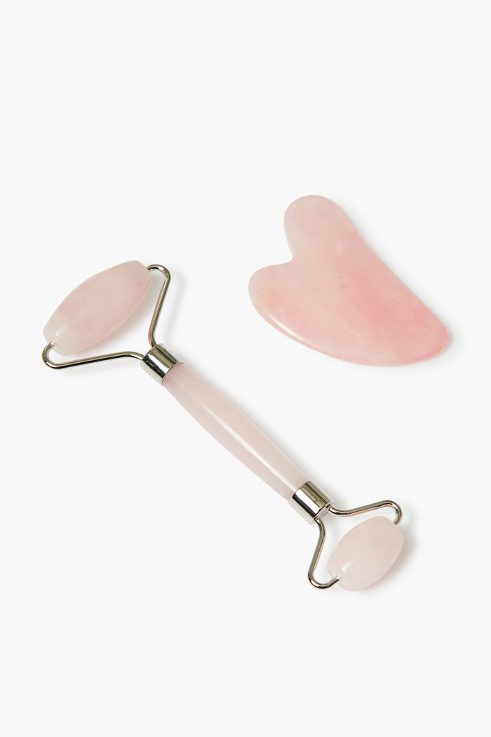 The Mount Lai Rose Quartz Facial Spa Set, featuring a pink facial roller and matching heart-shaped gua sha tool, is elegantly arranged.
