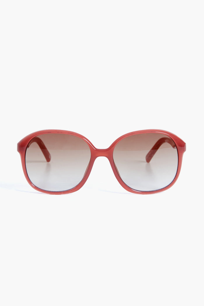 Le Specs red oval sunglasses with dark gradient lenses capture the bold style of the Rose Rouge Stupid Cupid collection.