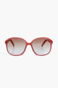 Le Specs red oval sunglasses with dark gradient lenses capture the bold style of the Rose Rouge Stupid Cupid collection.