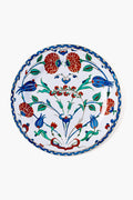 A decorative tin plate by One Hundred 80 Degrees features a floral and bird motif in red, blue, and green with intricate patterns. This easy-to-clean tableware adds charm and elegance to your dining experience.