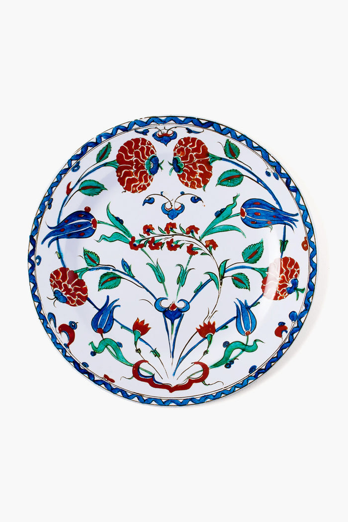 A decorative tin plate by One Hundred 80 Degrees features a floral and bird motif in red, blue, and green with intricate patterns. This easy-to-clean tableware adds charm and elegance to your dining experience.