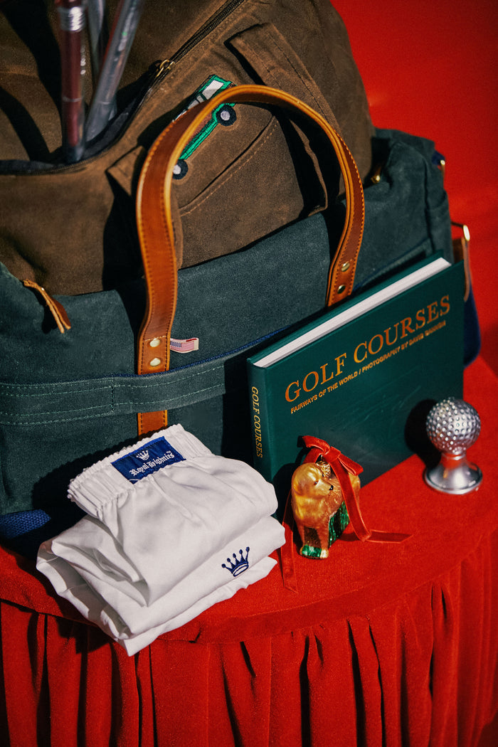 Royal Highnies Boxers (Set of 2) in a classic, effortless still-life with a golf-themed book, dog figurine, and tote, embodying high-end, fun style.
