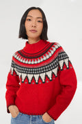 A woman in a cozy knit sweater, her vibrant Saylor Ceylona sweater adding a pop of color.