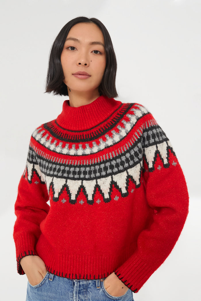 A woman in a cozy knit sweater, her vibrant Saylor Ceylona sweater adding a pop of color.