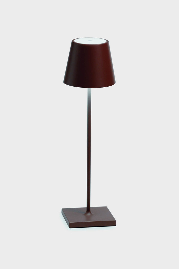 The Zafferano LED table lamp features a modern, minimalist design with a brown base, slender stem, and conical shade, adding elegance to any space.
