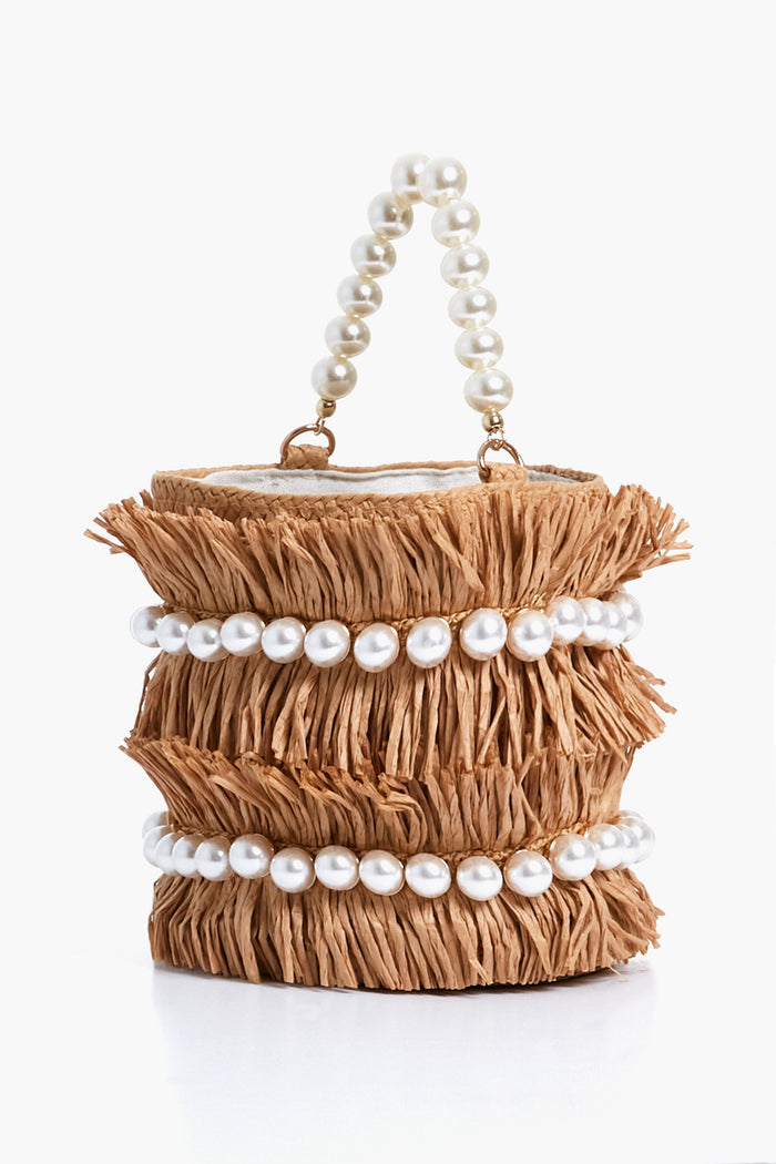The BTB small cylindrical straw fringe bag, adorned with two rows of large white pearls and a pearl handle, is a charming boho-chic accessory.