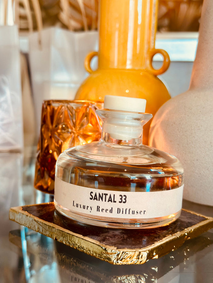Elevate your home fragrance game with our Santal Clear Glass Reed Diffuser.

Inspired by the luxurious Santal 33 by Le Labo, our 200ml diffuser adds a touch of sophistication to any space. Enjoy the long-lasting scent of this high-quality dupe in a sleek and modern clear glass design. Comes complete with 5 black fibre reeds.