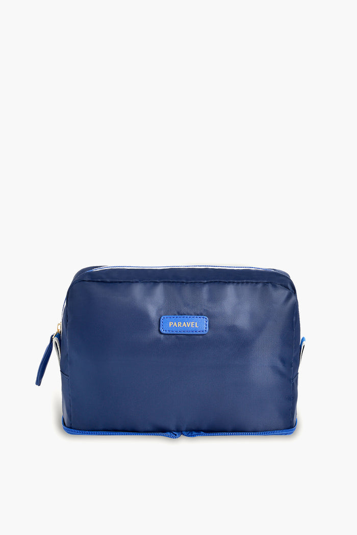 A blue rectangular zippered toiletry bag by Paravel, featuring a small front label—ideal for use as a travel organizer.