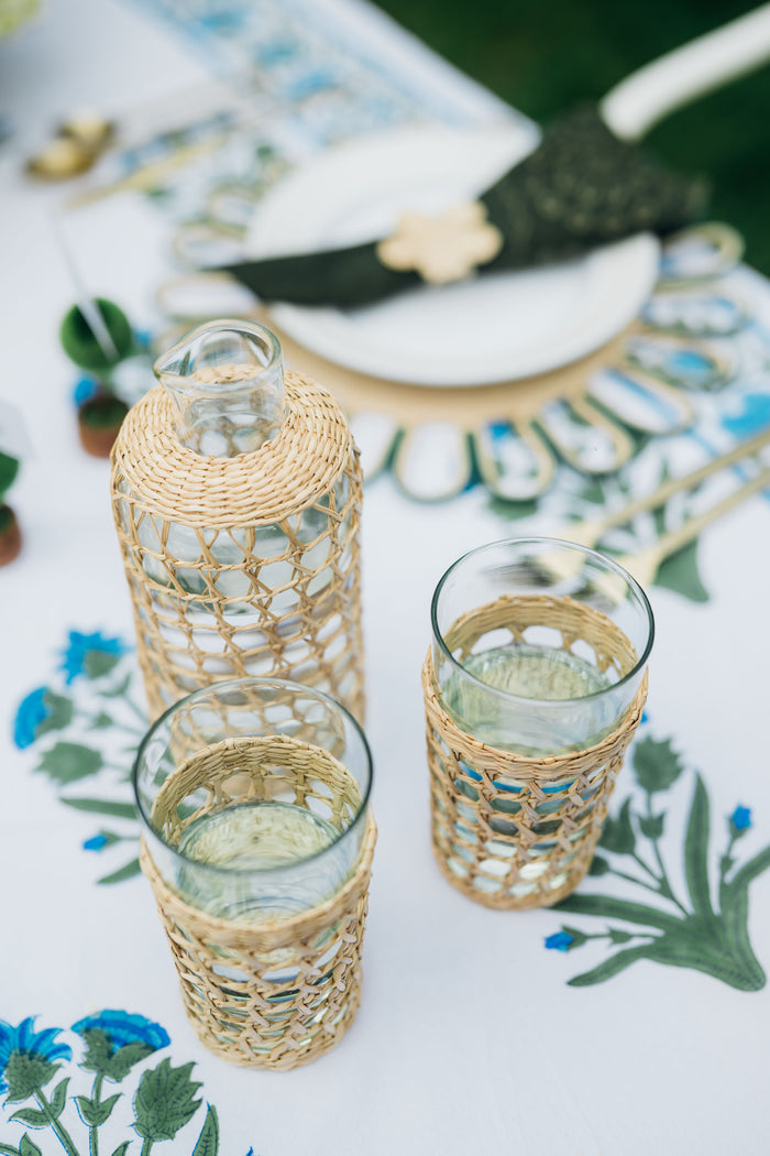 Seagrass Cage Highball Set of 6: Clear glass vessels with woven seagrass sleeves, offering a classic, effortless, high-end touch to any fun dining experience.