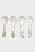 Four white plastic spoons by Be Home, featuring a marbled pattern inspired by Mother of Pearl, are arranged vertically in a row.