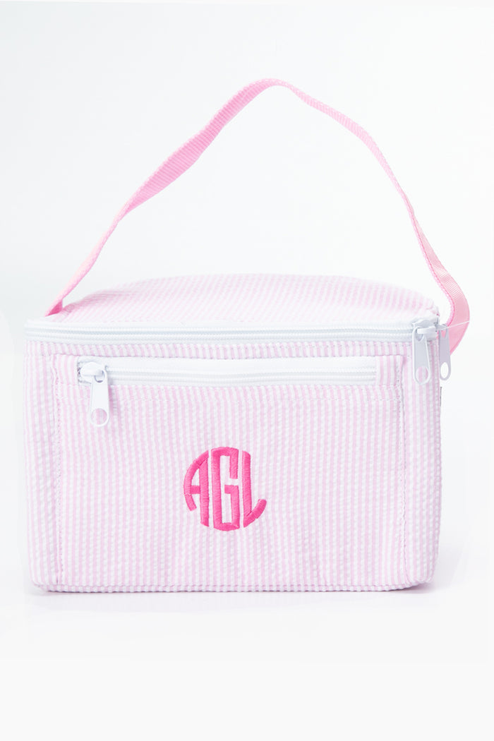 The Caton's Wharf Seersucker Lunch Box features pink and white stripes, a handle, two zippers, and AGL initials embroidered on the front.