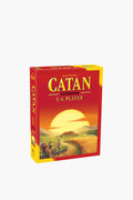 Catan Studio's Catan Expansion for 5-6 players board game shows a sunset landscape with three figures walking along a path in the foreground.