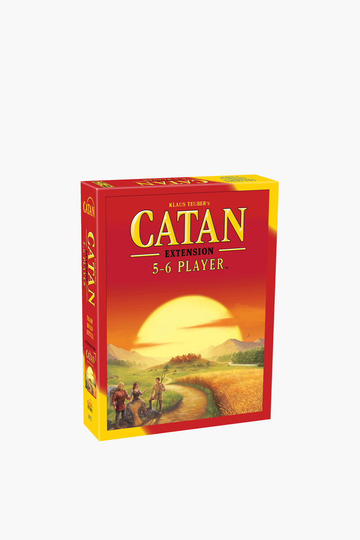 Catan Studio's Catan Expansion for 5-6 players board game shows a sunset landscape with three figures walking along a path in the foreground.