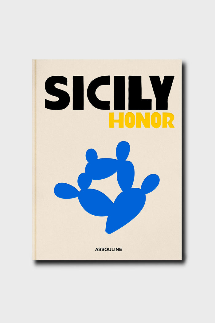 The book cover, titled SICILY HONOR, features bold black and yellow text with a blue abstract shape. Assouline’s name appears at the bottom, evoking the allure of Sicilian travel and notes of Sicilian cuisine.