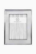 The Mariposa rectangular photo frame is handcrafted from recycled aluminum, features a smooth silver border, and displays a Mariposa insert with vertical gray lines—an eco-friendly addition to your home decor.
