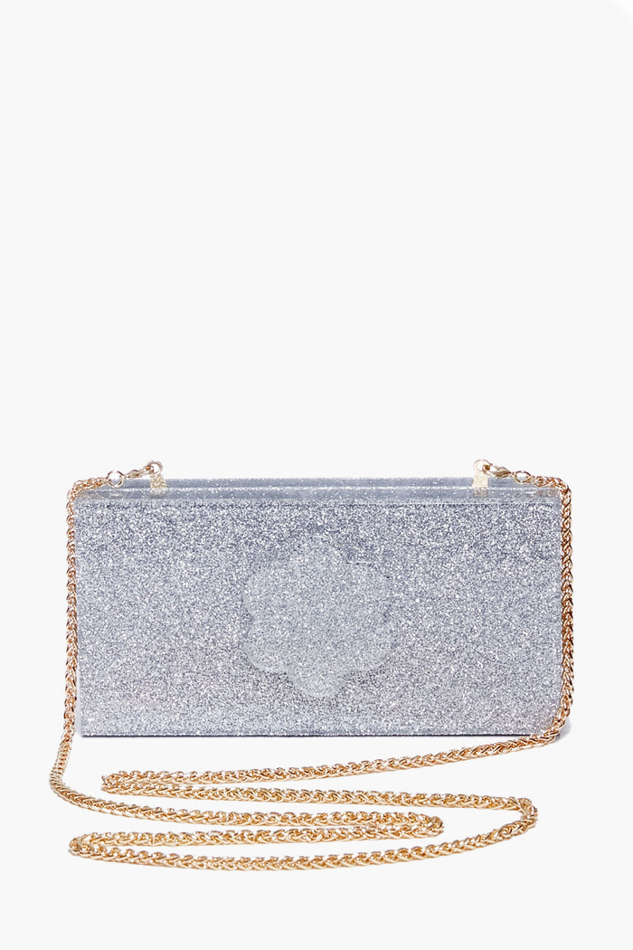 The ASHA Silver Sparkle Flower Clutch is a rectangular bag with a gold chain strap, dazzling glitter, and floral accents.