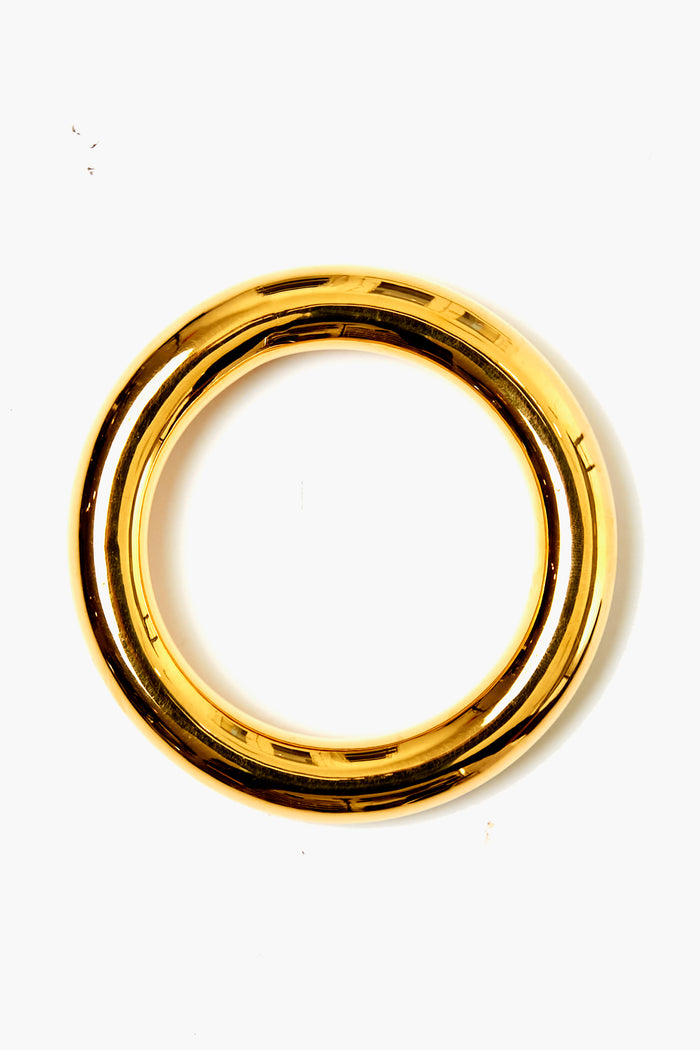 A polished, circular gold-plated brass bracelet from Lizzie Fortunato, inspired by their Small Gold Circuit Bangle.