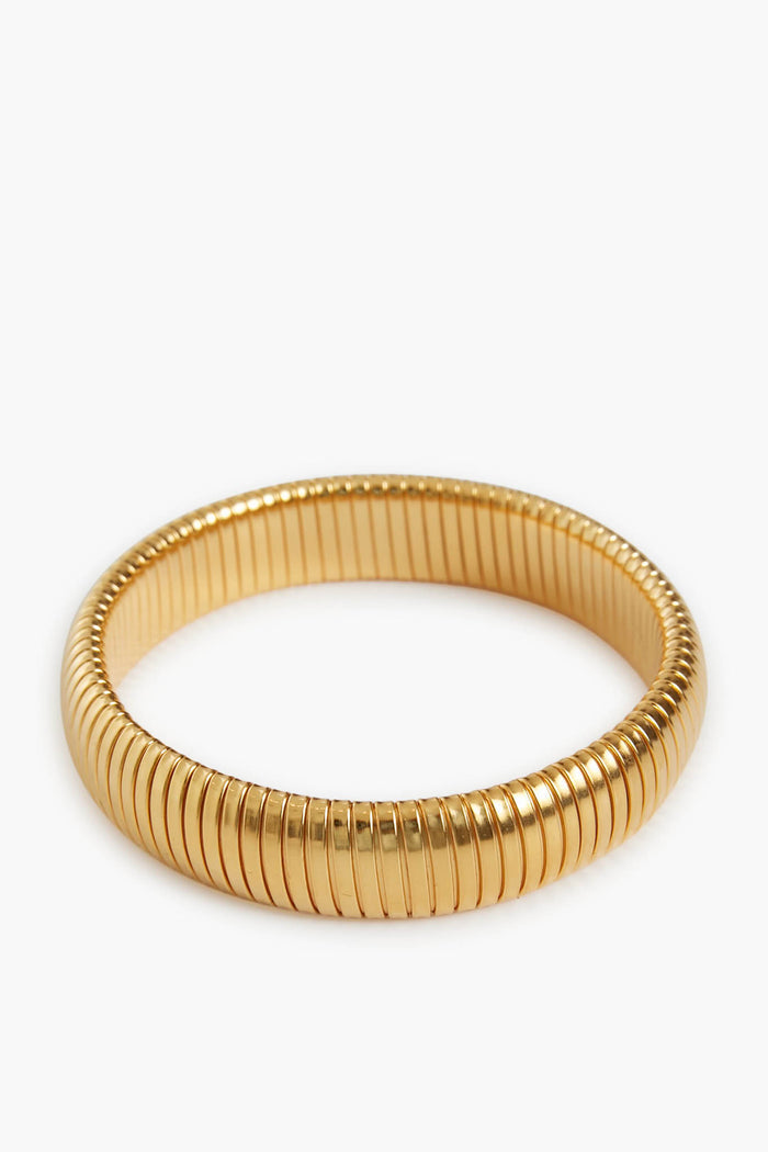 A gold-plated brass bangle by Ben Amun featuring a ribbed circular design and a smooth, reflective finish—an elegant statement bracelet.