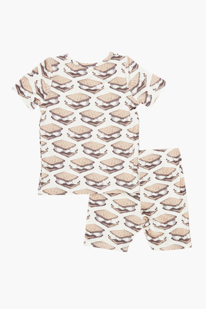 The Pink Chicken Smores Kids Bamboo PJ Set features an all-over s'mores print on a white shirt and shorts, displayed flat on a white surface.