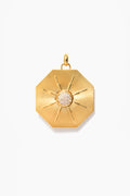 Tuckernuck Jewelry's Soleil Medallion necklace features an octagonal gold pendant with a textured, radiating pattern and a central cluster of small round white stones.