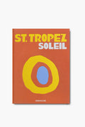 The cover of Assouline's book St. Tropez Soleil features bold yellow and white text with an abstract yellow and blue oval design.