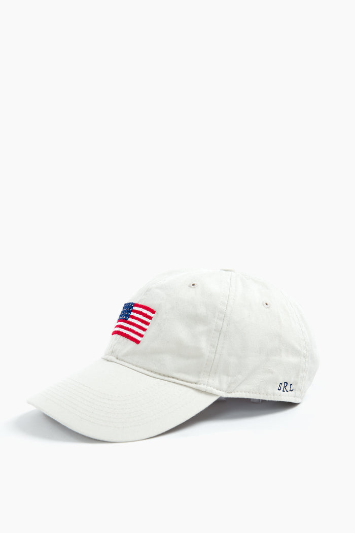 A white cotton twill hat from Smathers and Branson, featuring an embroidered American flag on the front and SRL initials stitched on the side—ideal for unique gifts.
