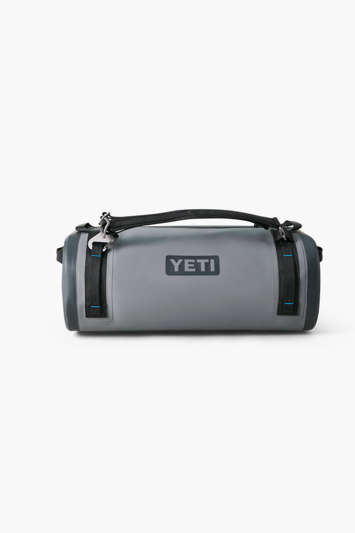 A durable gray YETI waterproof duffel with black straps and a top handle, ideal for outdoor adventures as a reliable gear bag.