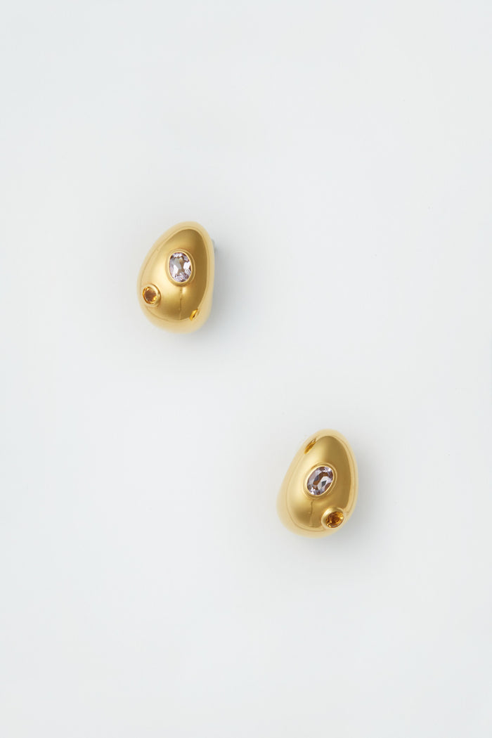 Lizzie Fortunato’s irregularly shaped gold mini arp earrings, each with a small semiprecious stone, celebrate the artistry of handcrafted jewelry.