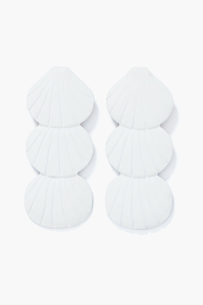 Sunshine Tienda’s white seashell earrings feature stacked shell shapes and lightweight, hand-painted design.