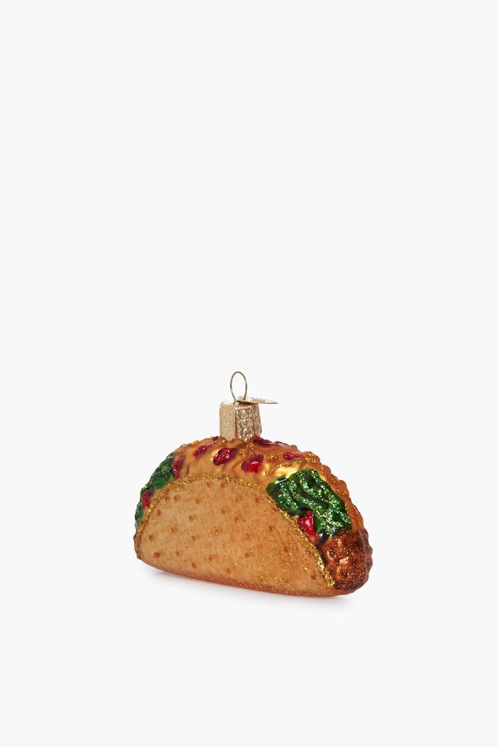 A hand-painted glass taco ornament by Old World Christmas, featuring colorful toppings and a gold hanging cap—perfect for brightening up your décor.