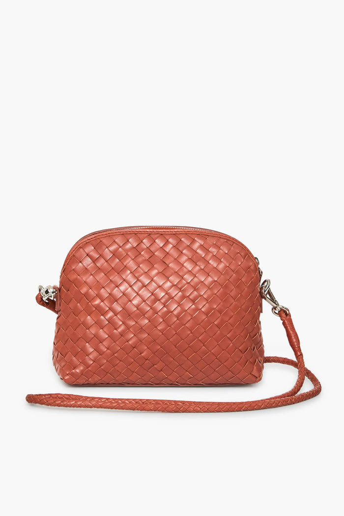 Dragon Diffusion presents a small crossbody bag in reddish-brown Italian cow leather with a woven pattern, silver hardware, and a matching braided strap. Handmade in India, it showcases the brands artistry in woven leather bags.