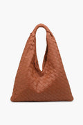 The Moda Luxe brown woven leather handbag features a triangular shape and single handle, making it a stylish choice as a trendy shoulder bag or woven tote.