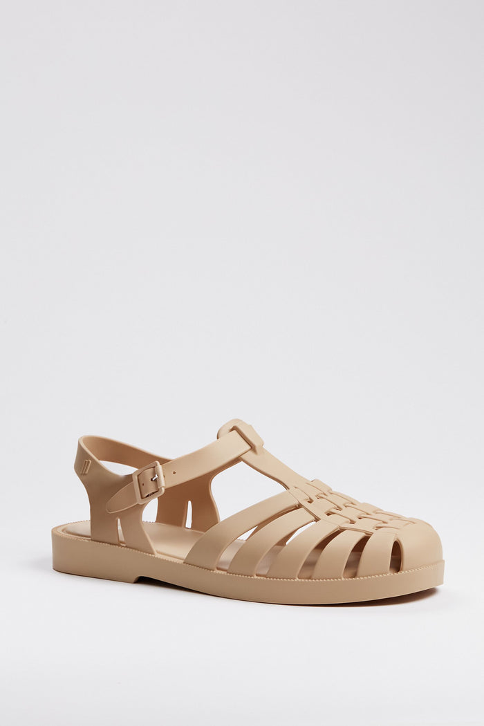 Melissa beige jelly sandal with closed toe, woven design, adjustable buckle strap, and flat sole—a stylish and iconic choice for sustainable fashion enthusiasts.