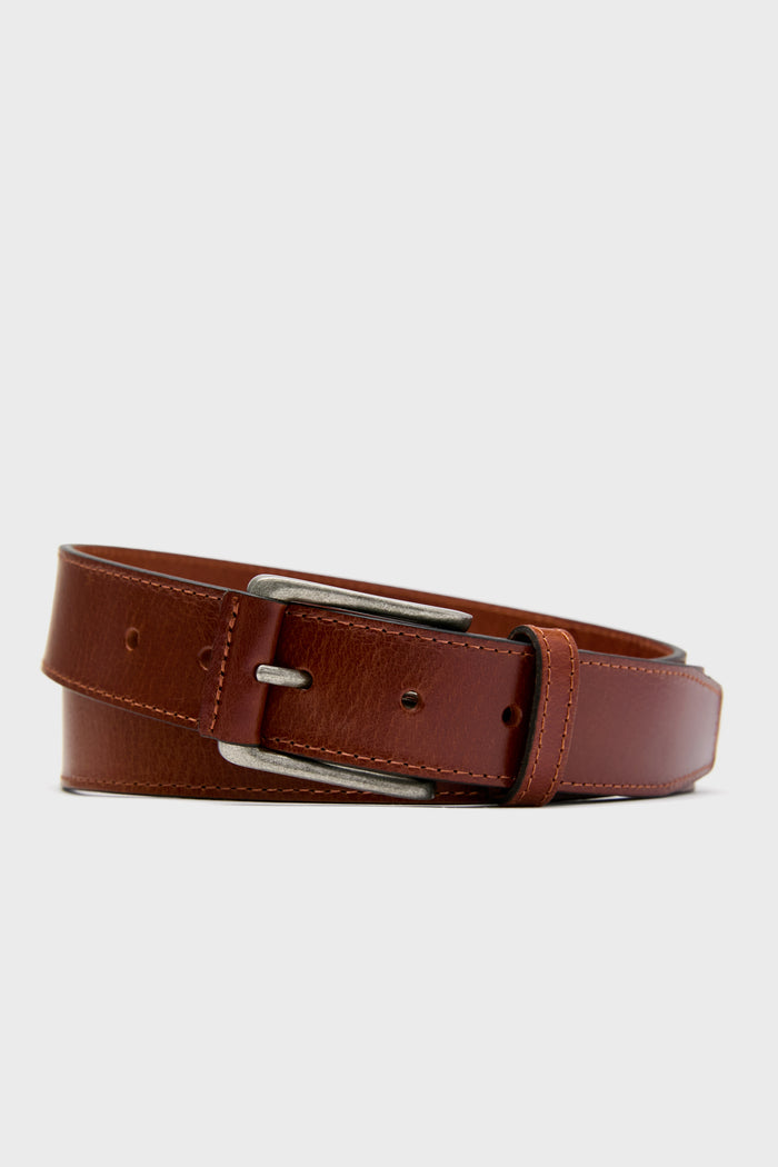 The Trafalgar brown men's leather belt features a silver rectangular buckle and coiled design, highlighting its genuine leather craftsmanship—a premium accessory for any wardrobe.