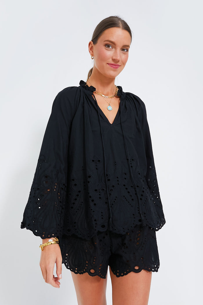 A woman in a Natalie Martin black embroidered blouse.
