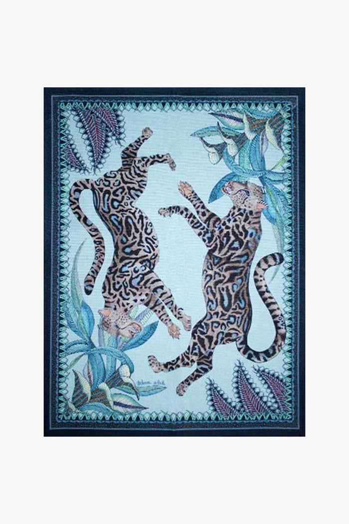 Vibrant illustration of two leopards with patterned fur, set amid blue and green tropical leaves and a decorative frame—inspired by South African artistry and the Ardmore Design Tanzanite Cheetah Kings Tea Towel.