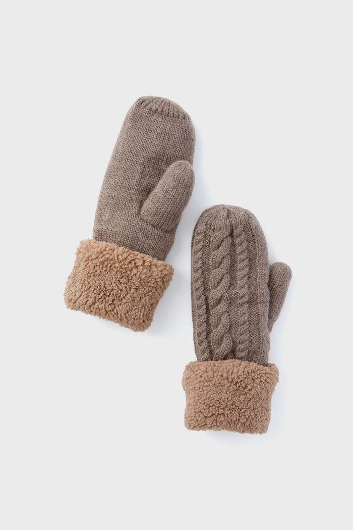 A pair of Hat Attack Taupe Flurry cable-knit mittens with textured patterns and fluffy cuffs—perfect cozy winter accessories.