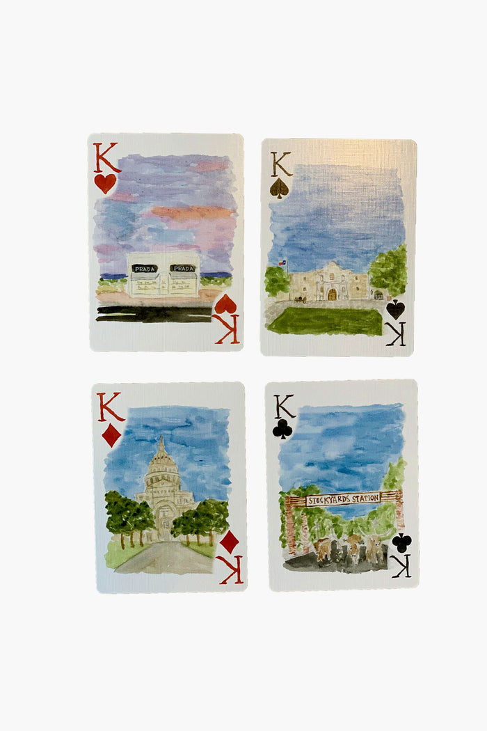 This LouLou Baker set features four King playing cards with hand-painted watercolor artwork of Texas landmarks, including buildings, a sign, and a statue. A perfect Texas playing card set for a unique hostess gift.