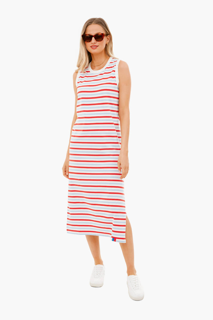 A woman wears a KULE sleeveless midi tank dress with horizontal red, white, and blue stripes in 100% cotton, styled with white sneakers and sunglasses.