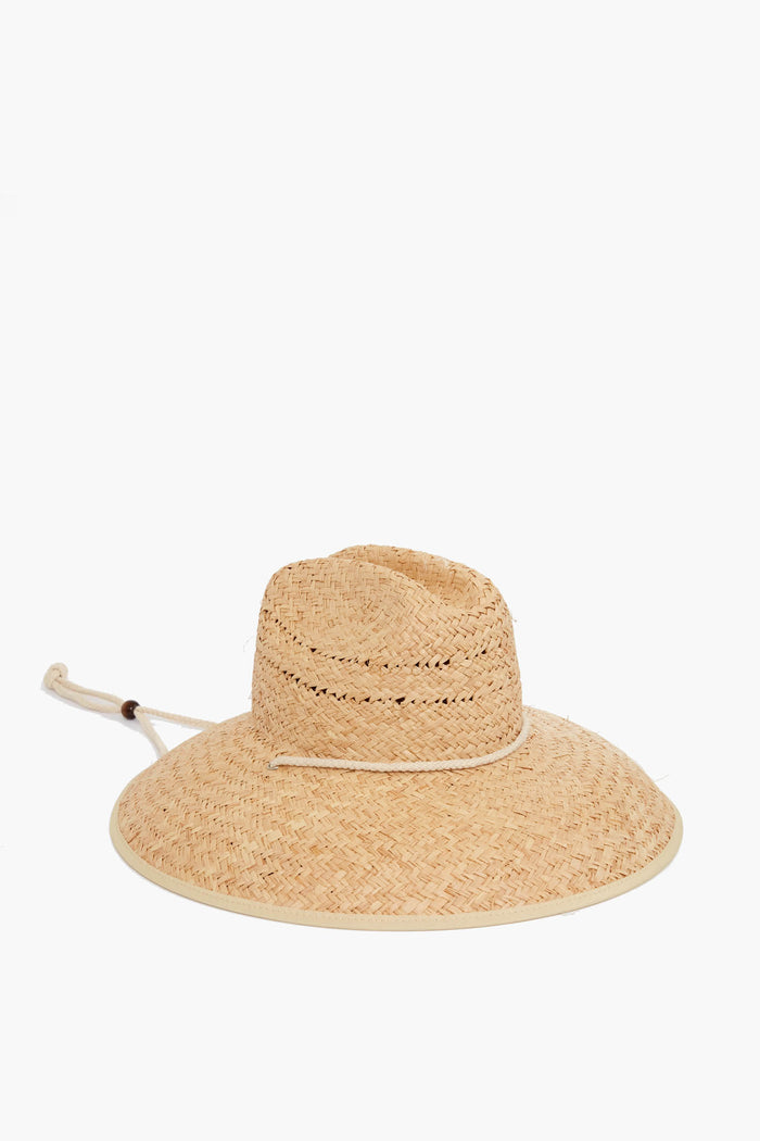 The Lack of Color wide-brimmed woven straw hat features a chin cord with bead, making it ideal for sunny days.