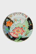 The One Hundred 80 Degrees Tobacco Leaf Tin Plate features a large pink and red flower, green leaves, orange floral accents, gold details, and a black border design.